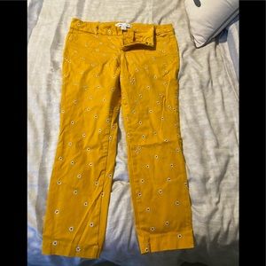 Yellow pixie jeans with daisies stitched in